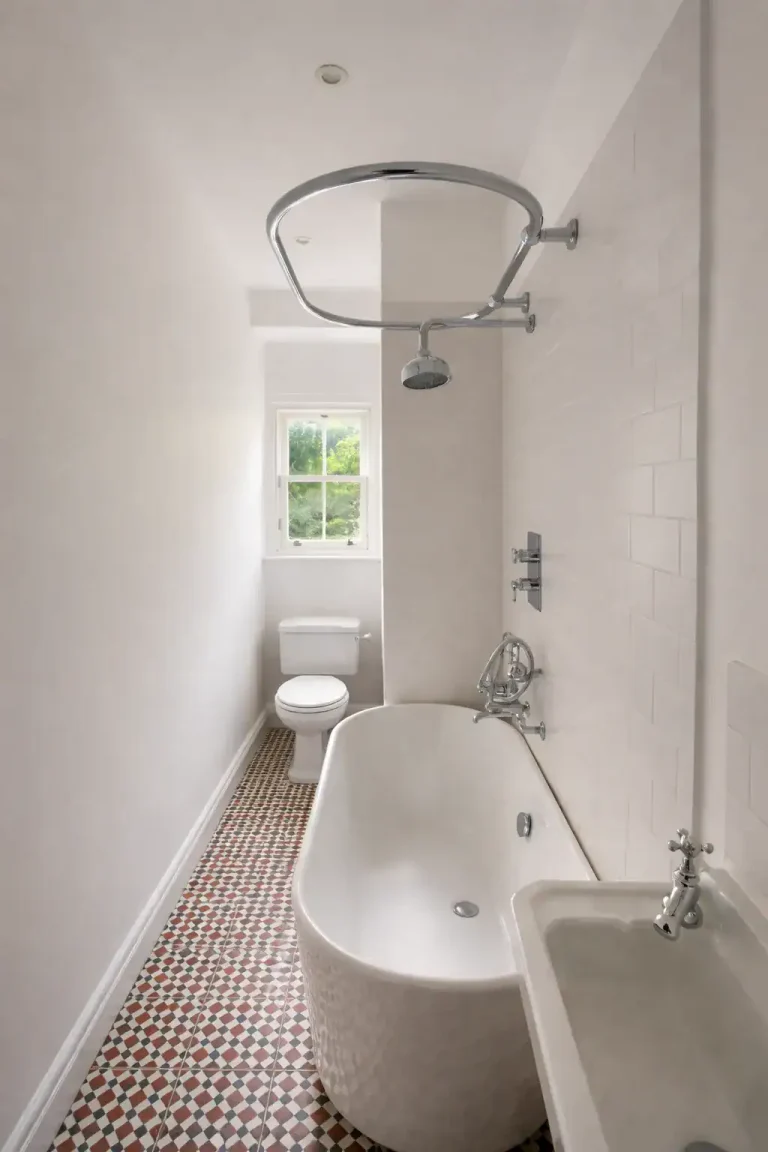 Modern bathroom fitting in an Edinburgh home with walk-in shower, wall-hung basin and tiled floor