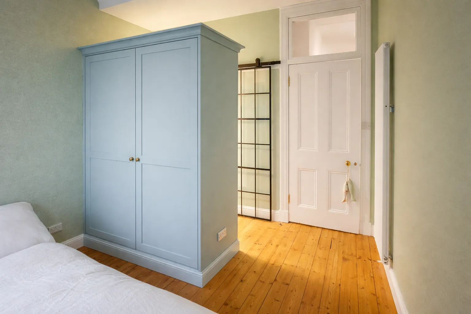 Fitted wardrobe following a sloping ceiling in an Edinburgh tenement